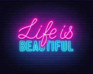 Life is Beautiful neon lettering on brick wall background.