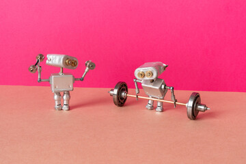 Robot weightlifter and robotics athlete train with heavy barbell and light fitness dumbbells. Power...