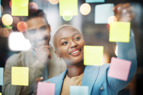 Planning, writing and business people in schedule, brainstorm or agenda, sticky note or innovation. Idea, partnership and happy black woman leader with solution goal, visual or problem solving answer