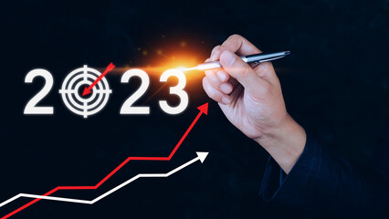 Business target and goal 2023 icon, hand pointing holding 2023 virtual screen and up arrow, Start new year 2023 with a goal plan, action plan, strategy, new year business vision.