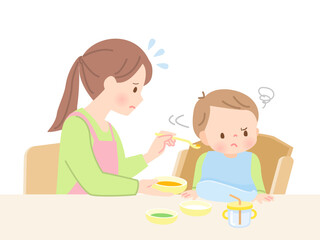 Obraz na płótnie Canvas 赤ちゃんに離乳食を食べさせるママと嫌がる赤ちゃん