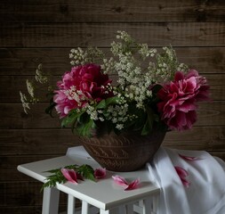 Still life with pink peonies and wild flowers.