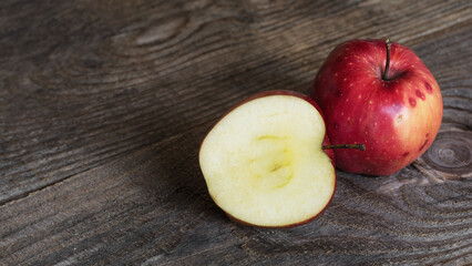 Cut red apple on a wooden background