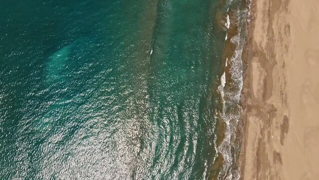 aerial sea watching people on the beach and wave foams view of the patara beach