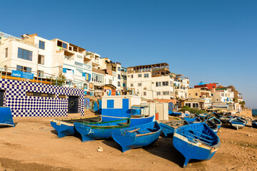 Blue wooden boats on the shore in Taghazout Village in Morocco © Lucas Puch
