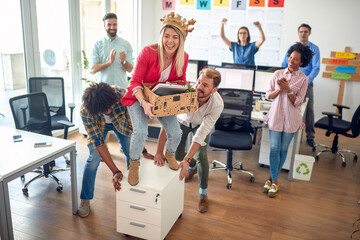 A young female employee is having fun with her colleagues in the office. Employees, job, office