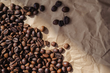 Coffee beans on brown paper background, can be used as a background