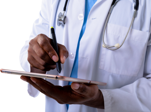 Mid section of african american male doctor using graphic tablet against white background