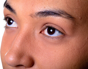 Fototapeta premium Close up of eyes of african american businesswoman against white background