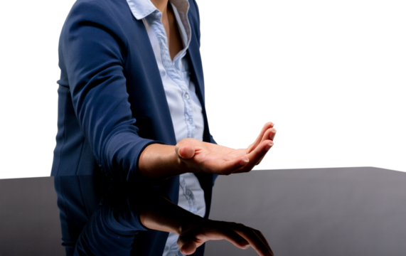 Mid section of businesswoman holding an invisible object against white background
