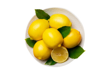 Fresh cutted lemon and whole lemons over round plate isolated on white background. Food and drink ingredients preparing. healthy eating theme top view with copy space