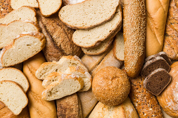 Homemade natural breads. Different kinds of fresh bread as background, top view with copy space