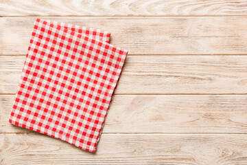 Obraz premium top view with red empty kitchen napkin isolated on table background. Folded cloth for mockup with copy space, Flat lay. Minimal style