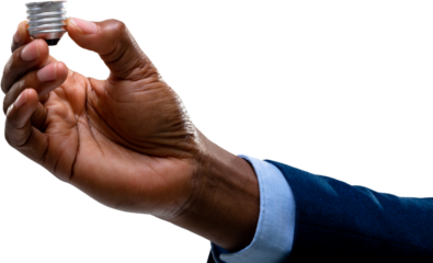 Close up of hand of businessman holding a bulb screw base against white background