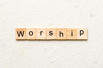 Worship word written on wood block. Worship text on cement table for your desing, concept