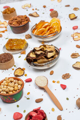 Healthy vegetarian food concept. Assortment of dried fruits, nuts and seeds on white background. Top view. Mixed nuts set closeup.