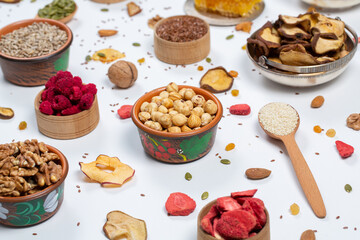 
Healthy vegetarian food concept. Assortment of dried fruits, nuts and seeds on white background. Top view.
