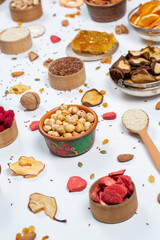 Healthy vegetarian food concept. Assortment of dried fruits, nuts and seeds on white background. Top view. Mixed nuts set closeup.