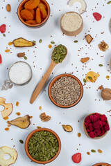 Healthy vegetarian food concept. Assortment of dried fruits, nuts and seeds on white background. Top view. Mixed nuts set closeup.