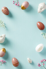 Happy Easter poster, vertical banner with Easter eggs, bunnies, minimalist flowers. Easter frame. Flat lay, top view.