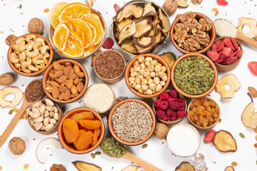 
Healthy vegetarian food concept. Assortment of dried fruits, nuts and seeds on white background. Top view.
