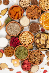 Healthy vegetarian food concept. Assortment of dried fruits, nuts and seeds on white background. Top view.