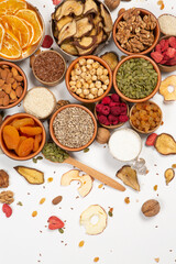 Healthy vegetarian food concept. Assortment of dried fruits, nuts and seeds on white background. Top view. Mixed nuts set closeup.