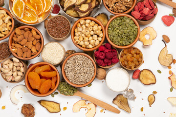Healthy vegetarian food concept. Assortment of dried fruits, nuts and seeds on white background. Top view. Mixed nuts set closeup.