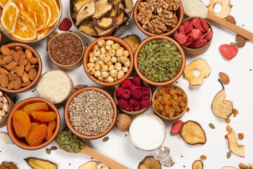 Healthy vegetarian food concept. Assortment of dried fruits, nuts and seeds on white background. Top view. Mixed nuts set closeup.