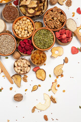 Healthy vegetarian food concept. Assortment of dried fruits, nuts and seeds on white background. Top view.