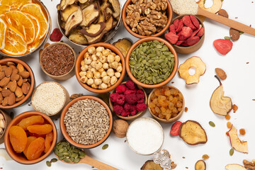 Healthy vegetarian food concept. Assortment of dried fruits, nuts and seeds on white background. Top view.