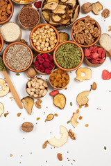 Healthy vegetarian food concept. Assortment of dried fruits, nuts and seeds on white background. Top view. Mixed nuts set closeup.