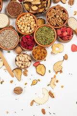 Healthy vegetarian food concept. Assortment of dried fruits, nuts and seeds on white background. Top view. Mixed nuts set closeup.