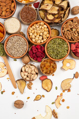 Healthy vegetarian food concept. Assortment of dried fruits, nuts and seeds on white background. Top view. Mixed nuts set closeup.