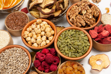 Healthy vegetarian food concept. Assortment of dried fruits, nuts and seeds on white background. Top view. Mixed nuts set closeup.