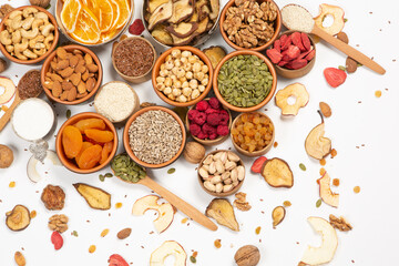 Healthy vegetarian food concept. Assortment of dried fruits, nuts and seeds on white background. Top view.