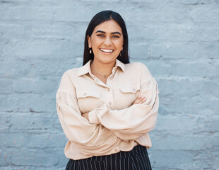 Portrait, business woman and arms crossed on brick wall background with pride for career. Smile,...