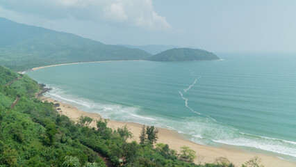 Sea coast in an arc against the backdrop of mountains
