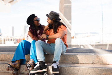 Cheerful couple with roller skating outside. Fun sexy boyfriend and girlfriend enjoy in sunny day.