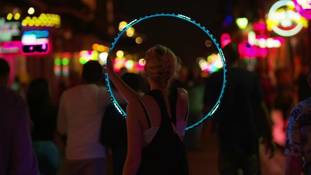 Slow Motion Shot Of Woman Performing With Illuminated Hula Hoop On Street At Night - Los Angeles, California