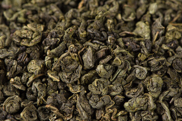 closeup of dry green tea leaves  background.