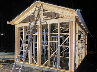 Obraz premium Wooden frame of a house under construction on a universal Swedish plate