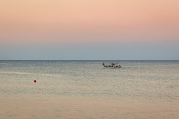 Fototapeta na wymiar Fish boat seen from shore in Protaras resort, Paralimni Municipality in Cyprus island country