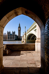 Big Ben and London Bridge frames in a stone arch