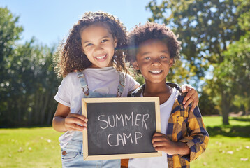 Summer camp sign, portrait or happy kids hug in park together for fun, bonding or playing in outdoors. Board, diversity or young best friends smiling or embracing on school holidays outside in nature
