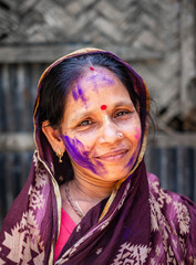 Portrait of a south asian elderly beautiful woman wearing traditional colourful clothes in holi...