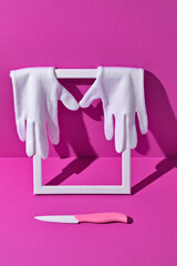 White Gloves and Ceramic Knife chef, cook on Magenta Background. fashion photo shoot with a daring accessory, a minimalist art installation with a pop of color
