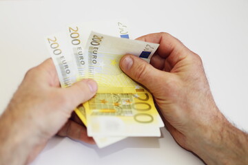 hand with euro banknotes
male hands with money count finance inflation earnings pay for work...
