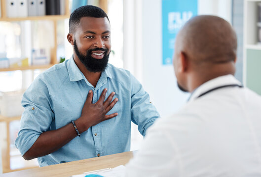 Doctor, patient and consulting in healthcare checkup, illness or appointment at the hospital. Black man talking to medical professional about chest pain, consultation or health problems at clinic