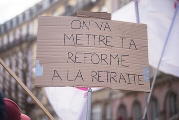 Closeup of placard in french : On va mettre ta reforme à la retraite, traduction in english : we retired your reform - 587296878